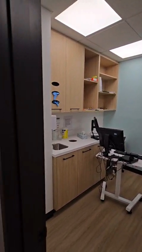 Bow Care Clinic exam room nook with wall cabinet and mounted monitor