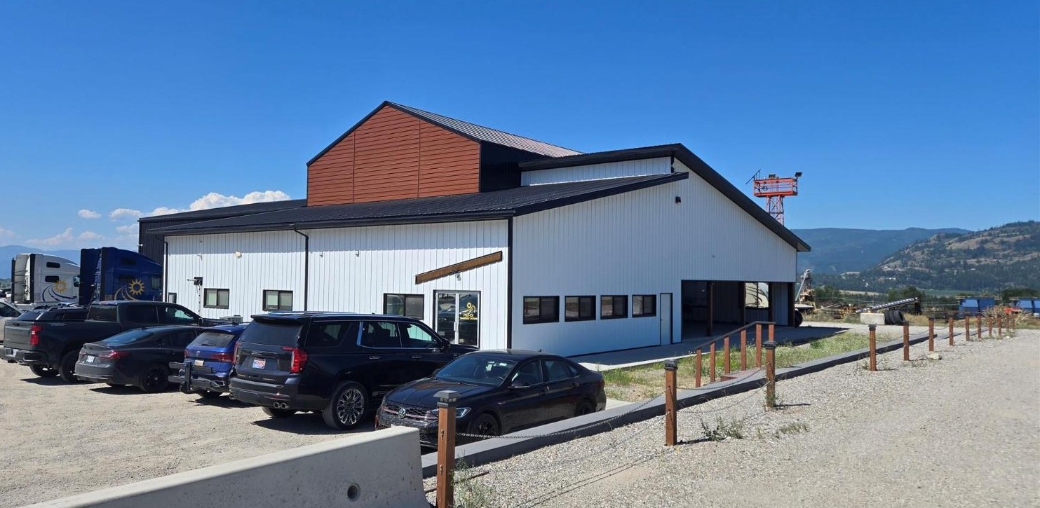 Integrity Buildings exterior with red gable accent and staff vehicles