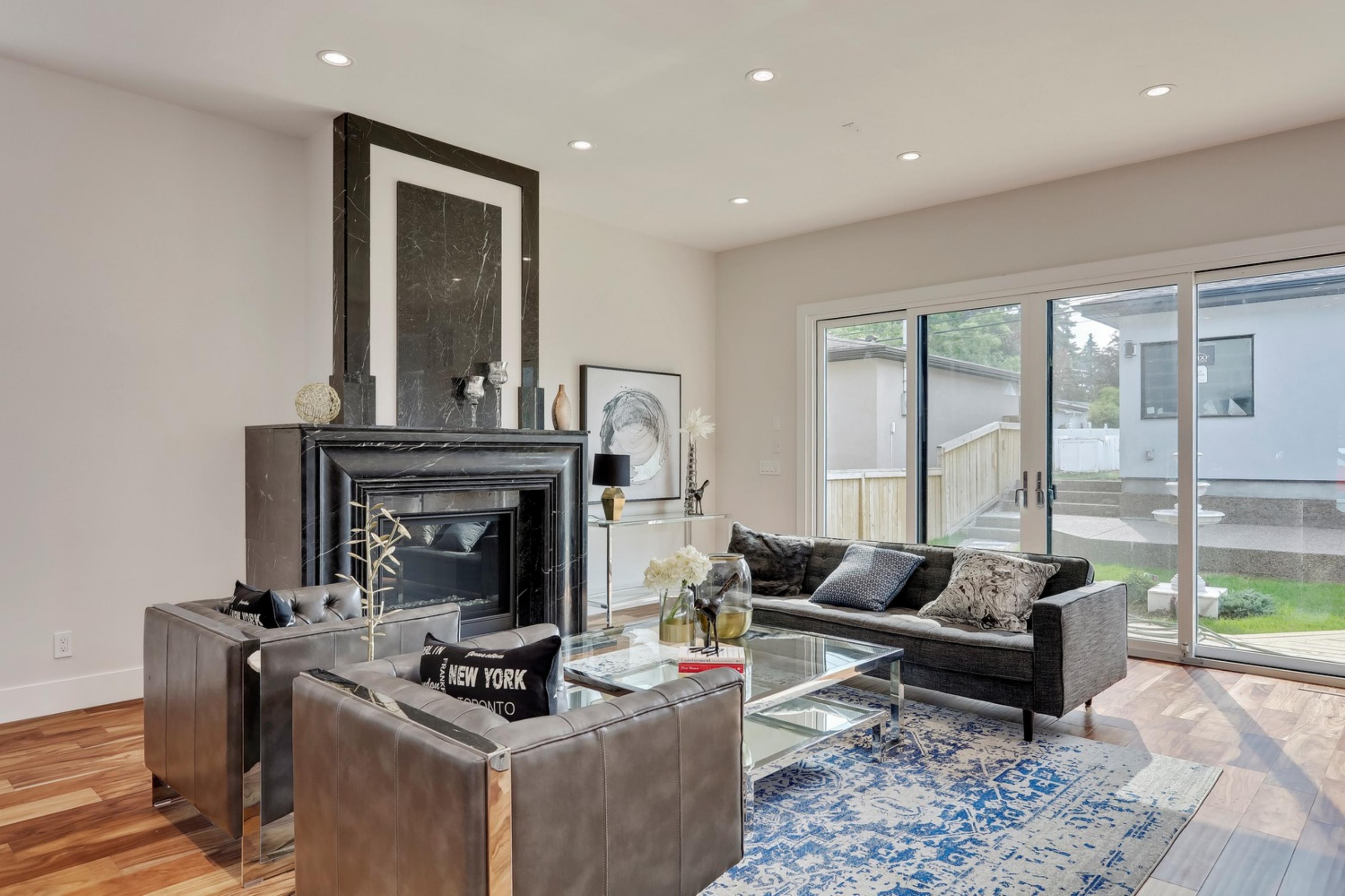 Killanery Custom Residence living room with black marble fireplace and leather seating