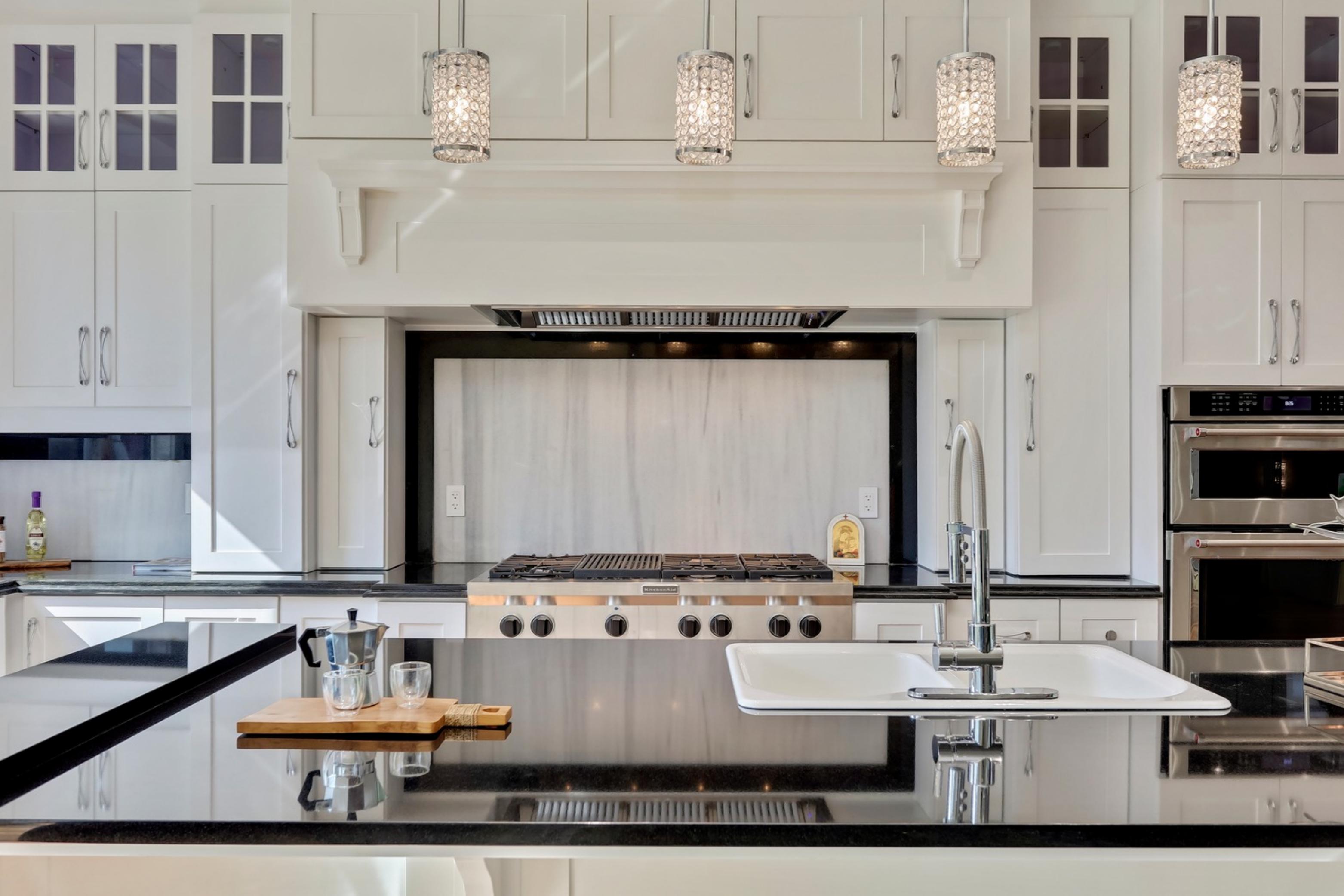 Killanery Custom Residence kitchen with white cabinetry and black countertops