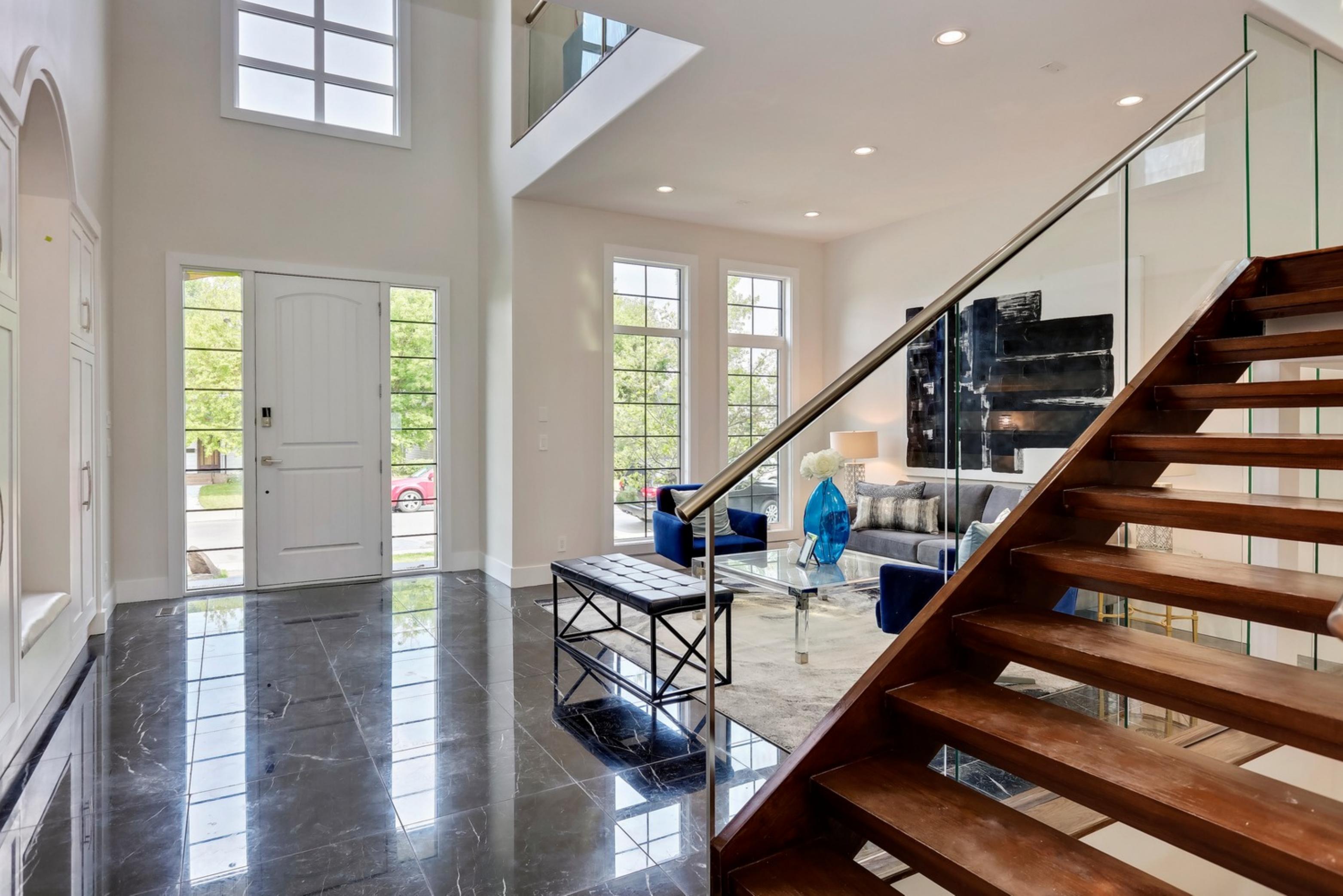 Killanery Custom Residence foyer with marble floor and glass-and-wood open staircase