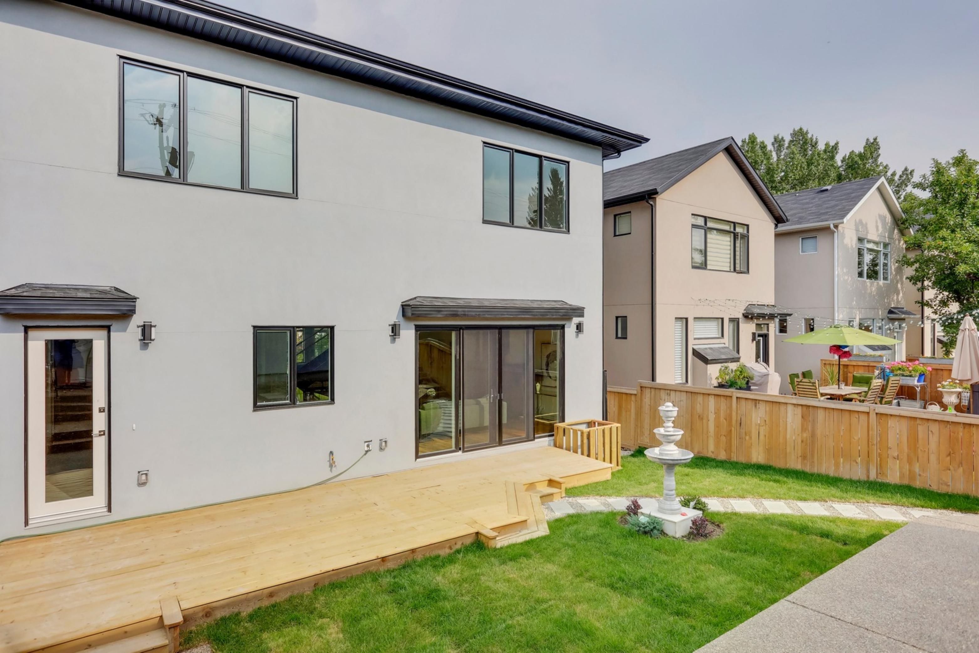 Killanery Custom Residence rear exterior with deck and sliding glass doors