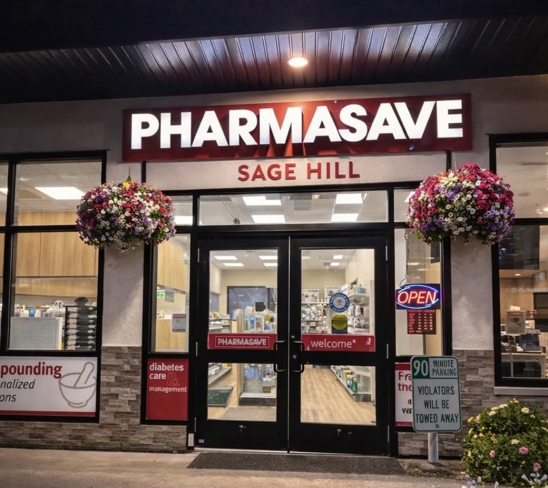 Pharmasave Sage Hill storefront entrance at dusk with signage